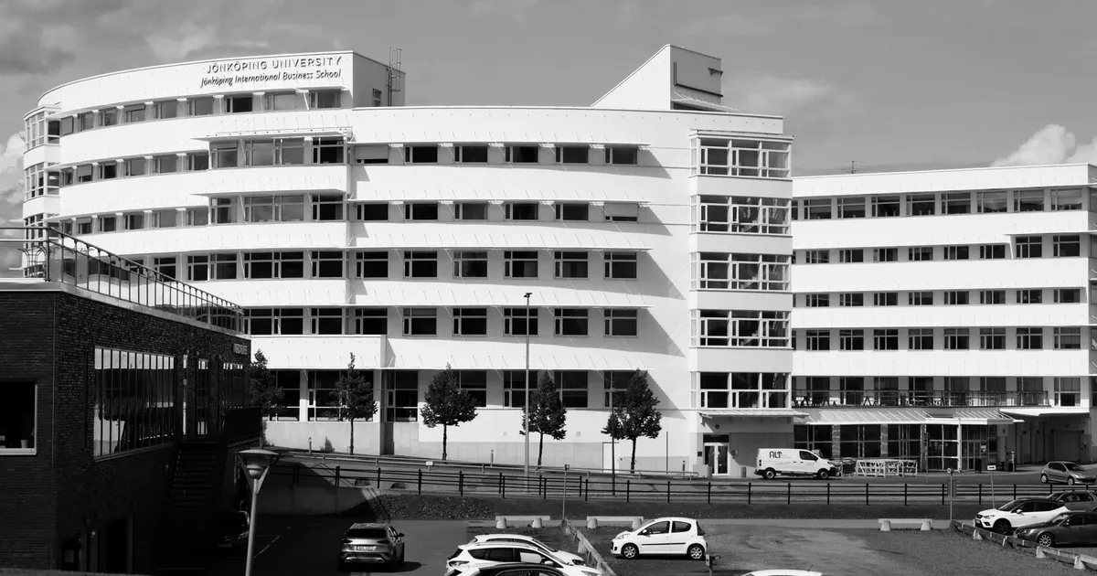 Black and white photo of Jönköping University in Sweden with parked cars.