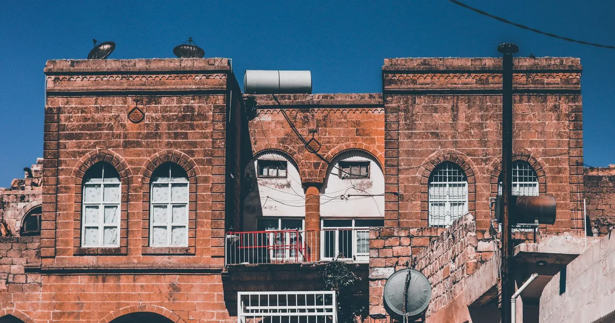 Stunning view of a traditional red brick building facade against a clear blue sky.