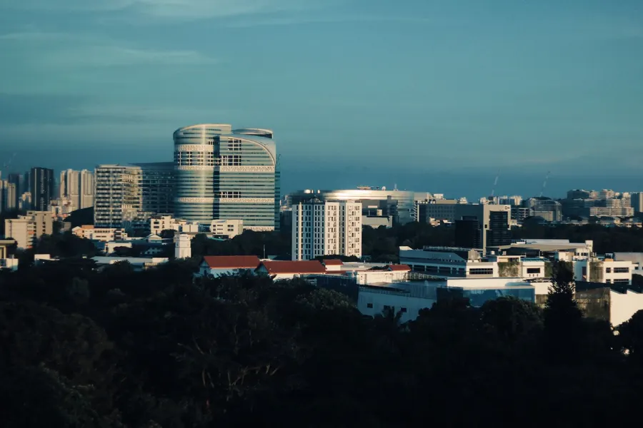 Skyline of Singapore featuring modern architecture under a clear blue sky.
