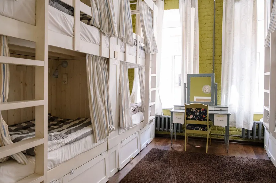 Comfortable hostel dorm room with clean bunk beds and a cozy ambiance.
