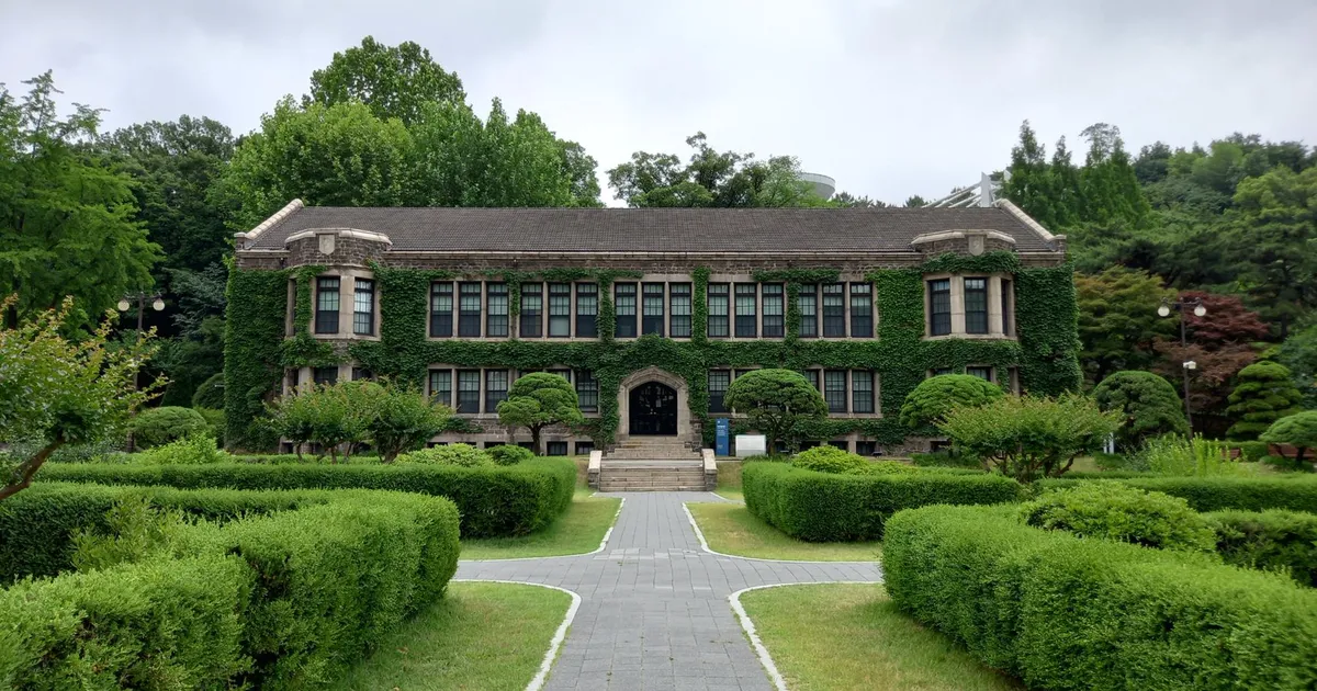 Historic building with ivy facade surrounded by lush greenery in Seoul, South Korea.