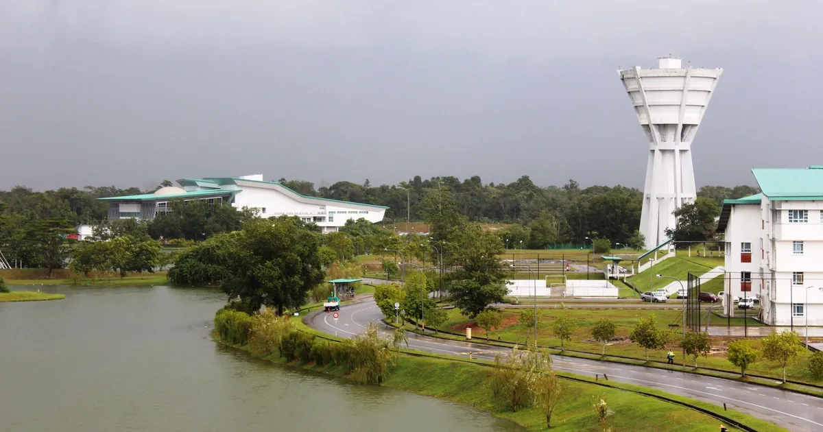 A beautiful campus with lush greenery and a calm lake in Kota Samarahan, Sarawak, Malaysia.