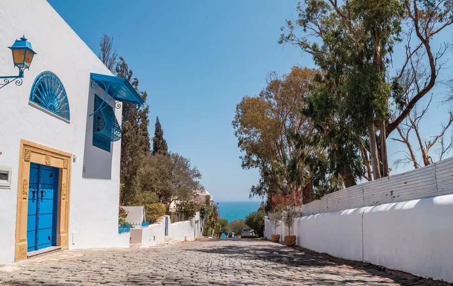 Beautiful Mediterranean street view in Carthage, Tunisia with blue sky and architecture.