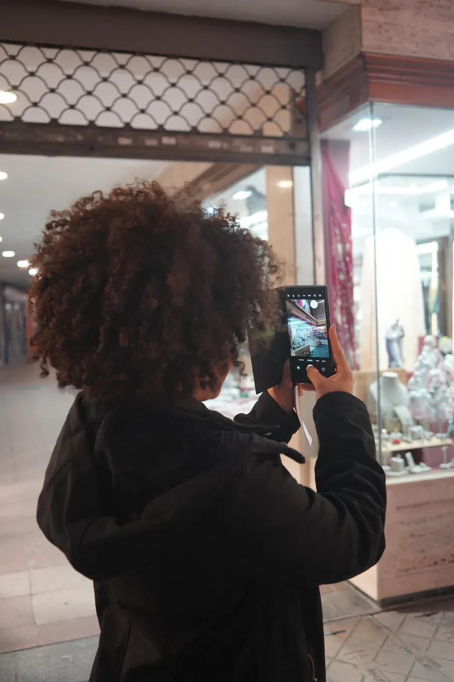 iPhone tenu en main avec écran allumé